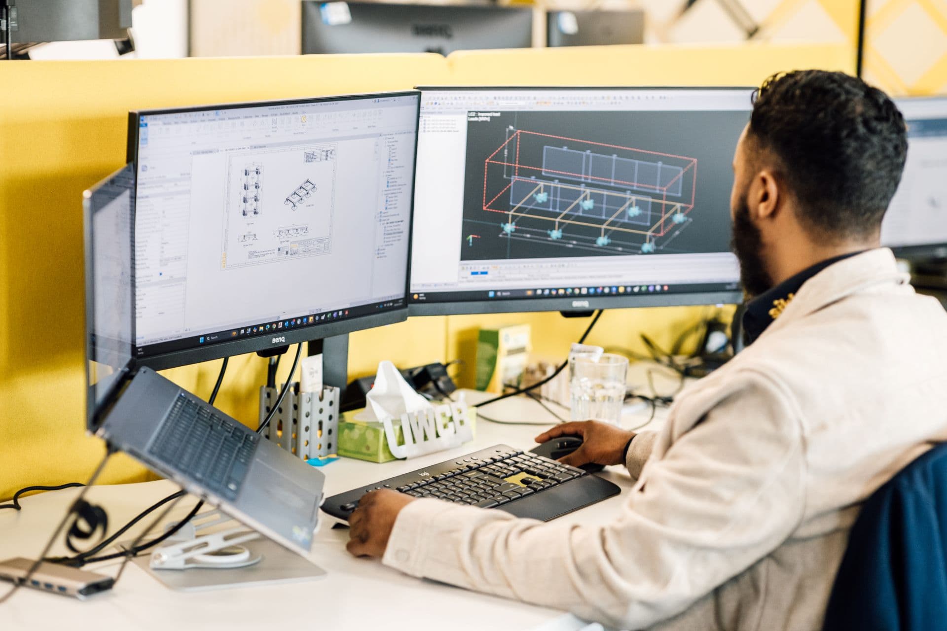 Sikla structural engineer using a computer at their desk to design a HVAC solution using BIM